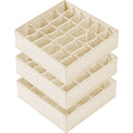 Stack of three beige fabric drawer organizers with multiple storage compartments.