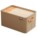 Brown fabric storage bin with side handles, neatly holding rolled and folded clothing.
