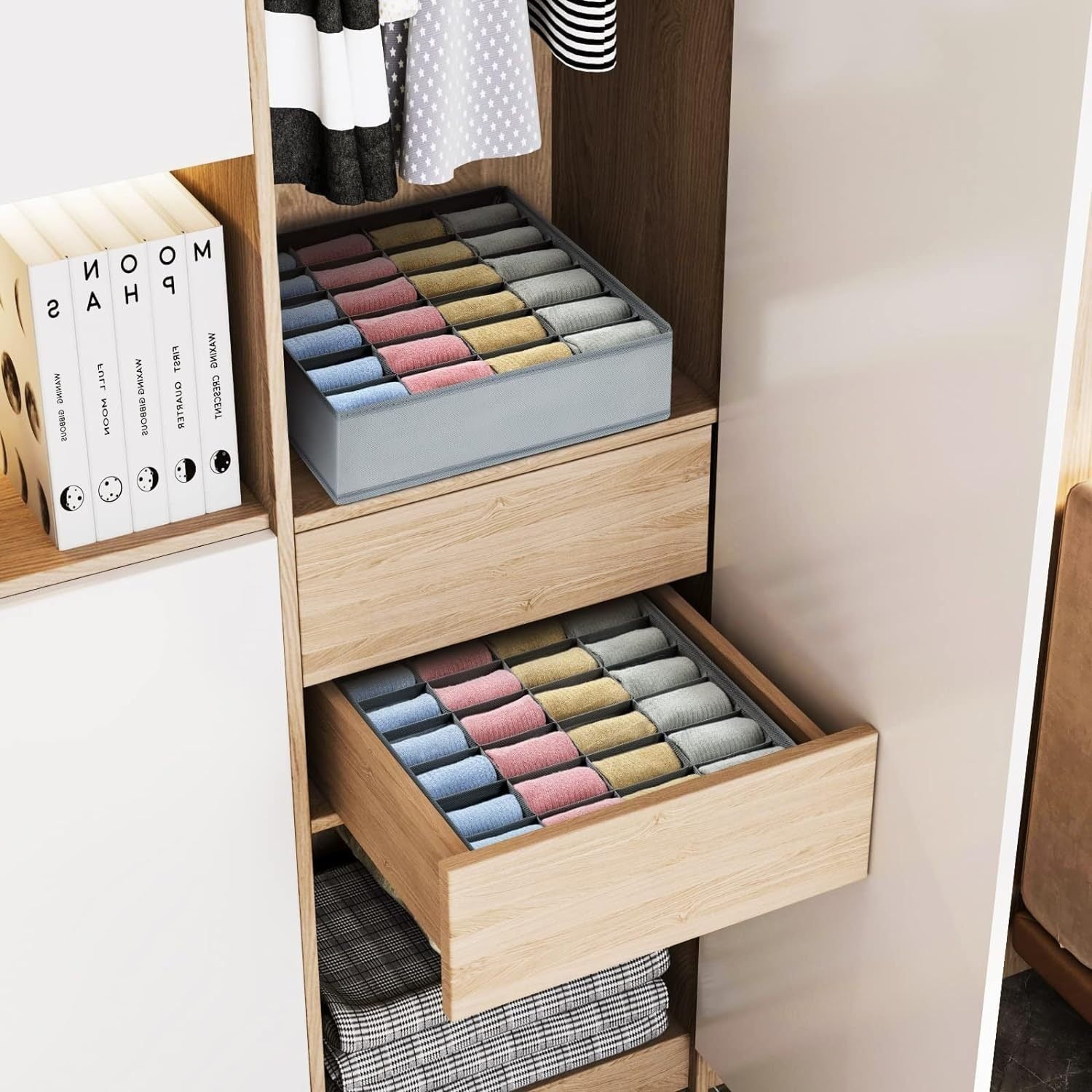 Closet drawer organizers filled with neatly rolled colorful socks, displayed on a shelf and inside an open wooden drawer.
