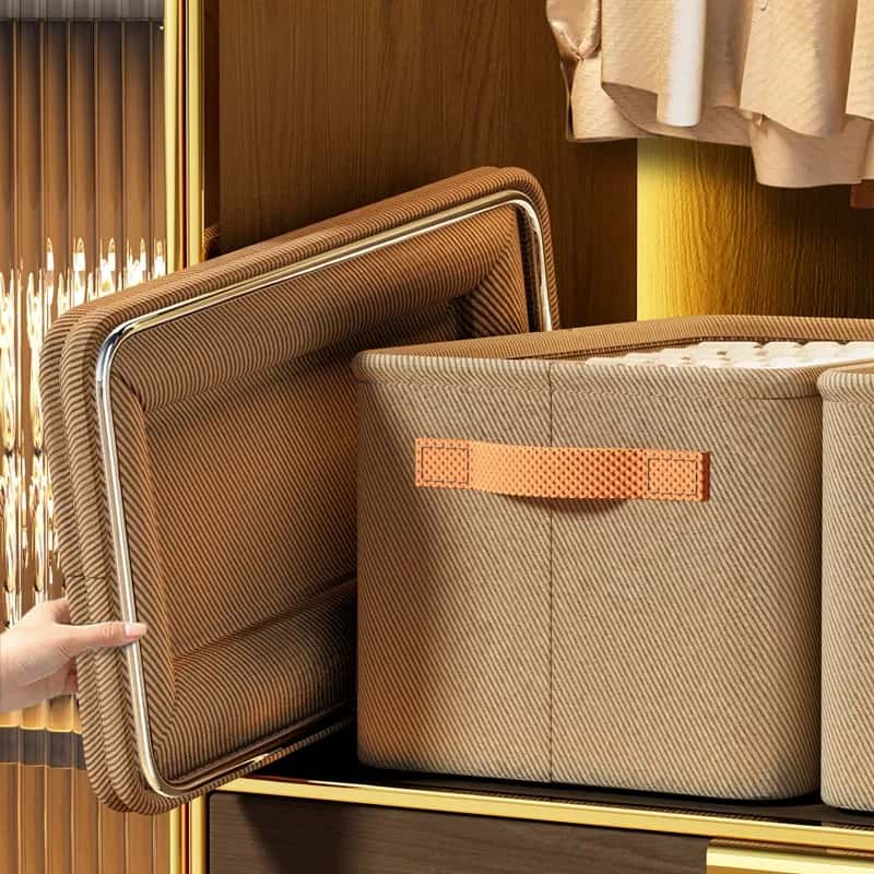 Brown fabric closet storage bin with a reinforced frame, side handle, and removable lid displayed on a shelf.